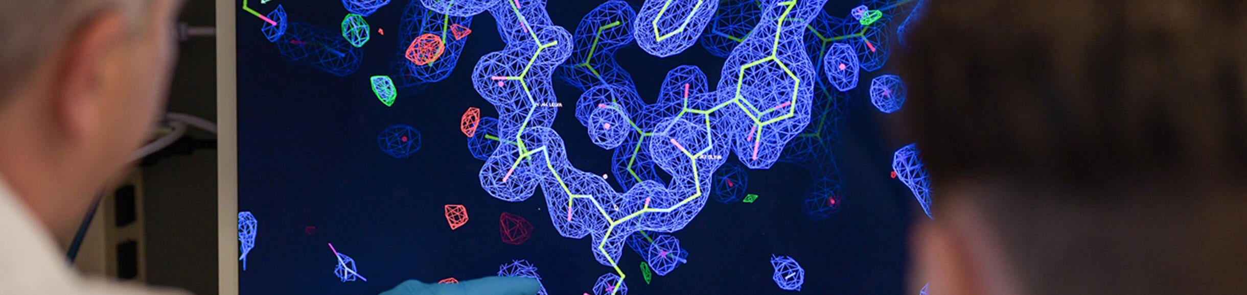 Researchers looking at a screen
