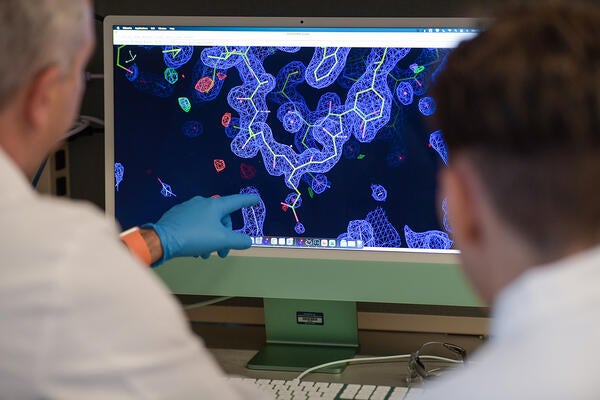 Researchers looking at a screen